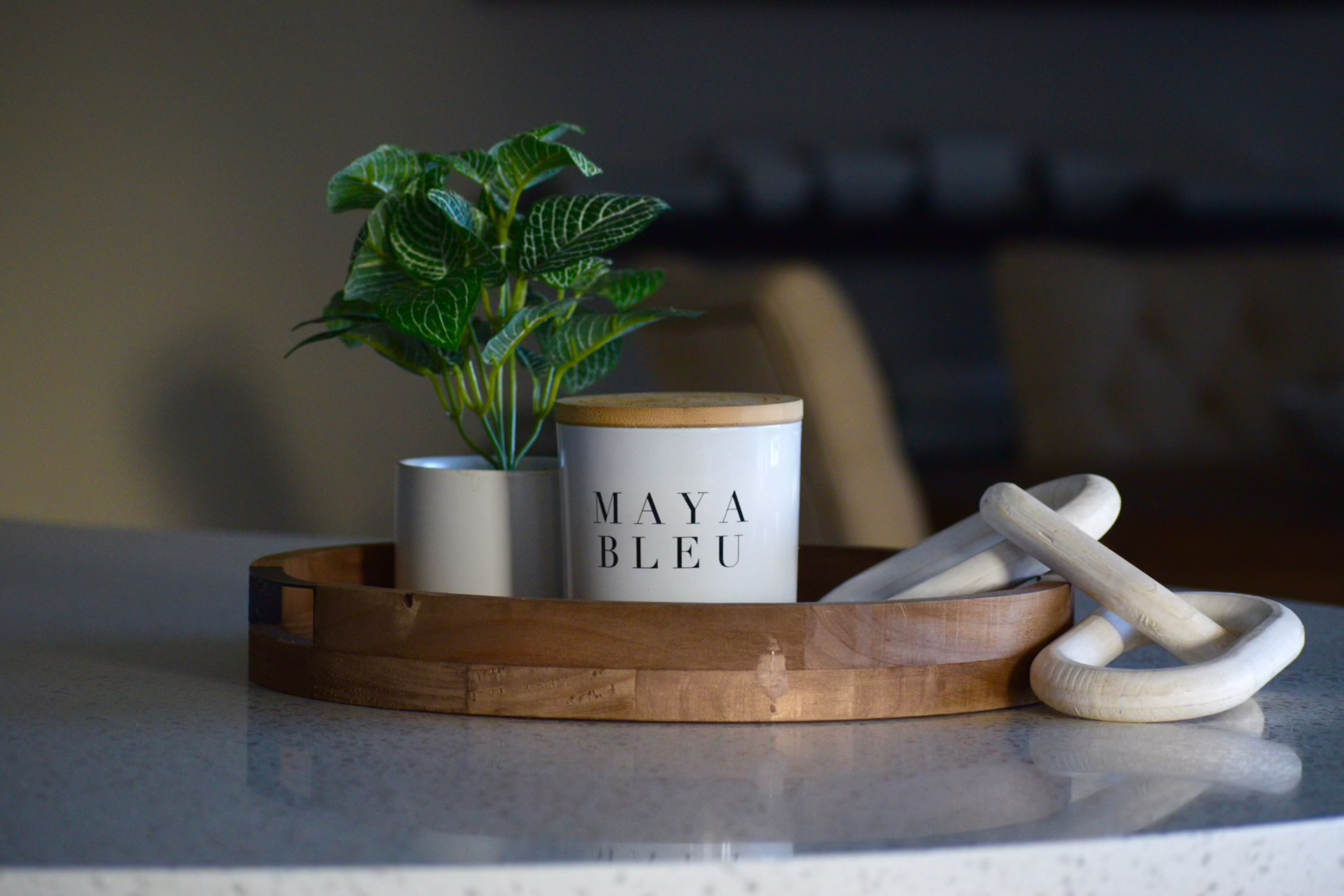 toxin free luxury soy candle displayed on a wooden tray beside a plant